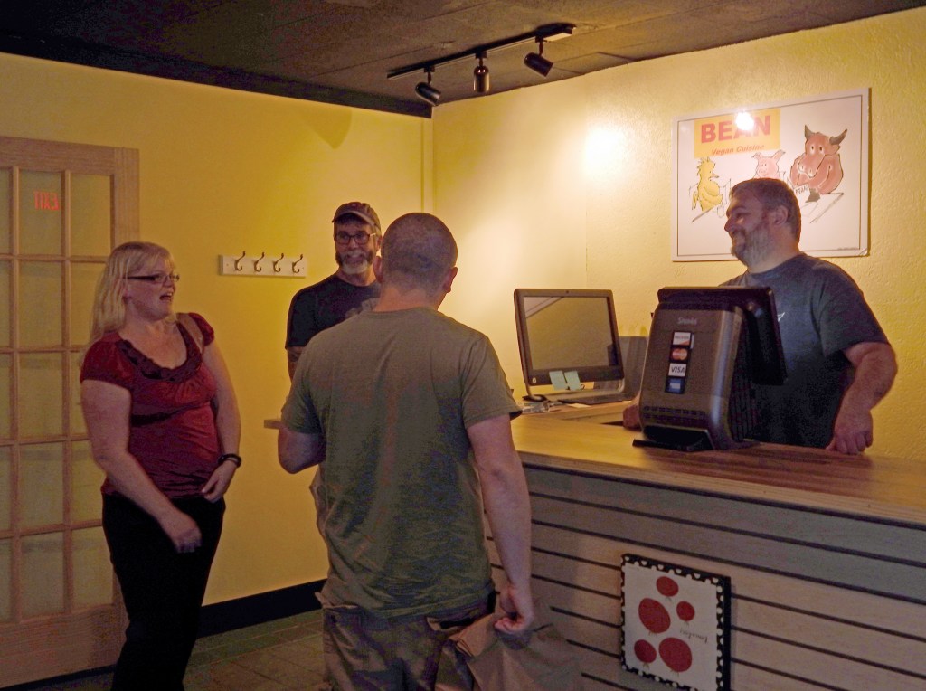 Roy rings up vegan purchases for two happy customers.