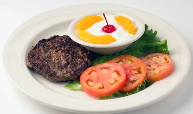 Typical "Diet Plate" of the 70s and 80s featuring salad, hamburger patty, cottage cheese, and peaches